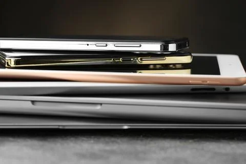 Stack of electronic devices on grey table, closeup 스톡 사진