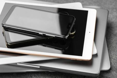 Stack of electronic devices on grey table, closeup Stock Photos
