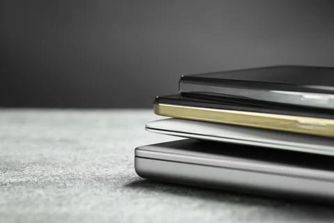 Stack of electronic devices on grey table, closeup. Space for text Foto stock