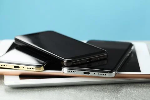Stack of electronic devices on grey table, closeup Foto stock