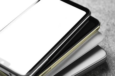 Stack of electronic devices on grey table, closeup 库存照片