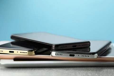 Stack of electronic devices on grey table, closeup Foto stock