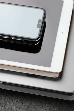 Stack of electronic devices on grey table, closeup Foto stock