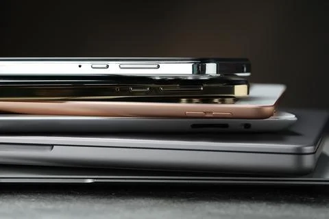 Stack of electronic devices on grey table, closeup 库存照片