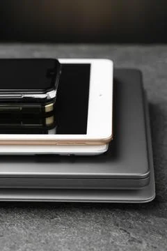 Stack of electronic devices on grey table, closeup Foto stock