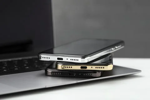 Stack of electronic devices on white table Foto stock