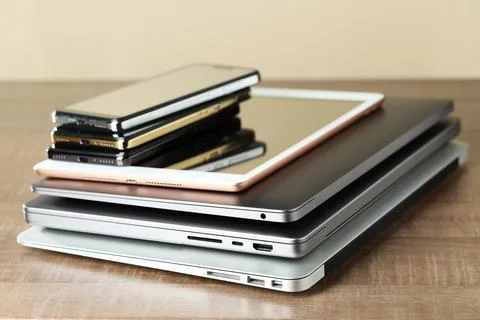 Stack of electronic devices on wooden table 스톡 사진