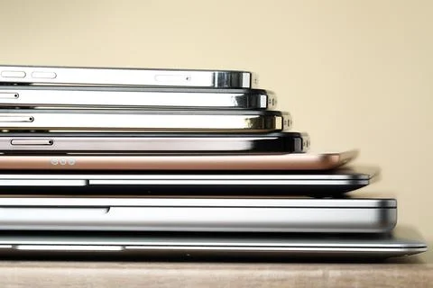 Stack of electronic devices on wooden table, closeup 스톡 사진