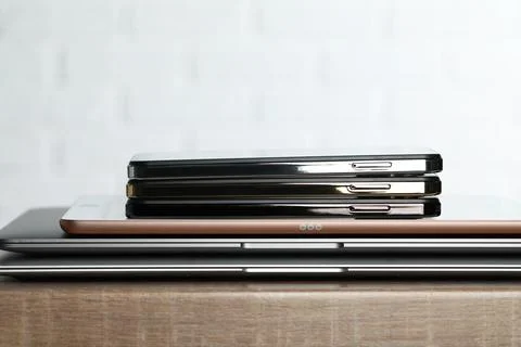 Stack of electronic devices on wooden table, closeup 스톡 사진