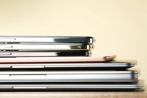 Stack of electronic devices on wooden table, closeup Foto stock