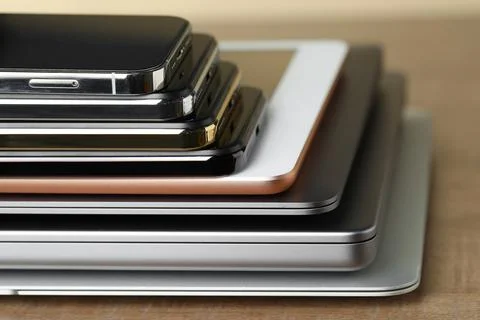 Stack of electronic devices on wooden table, closeup Stock Photos