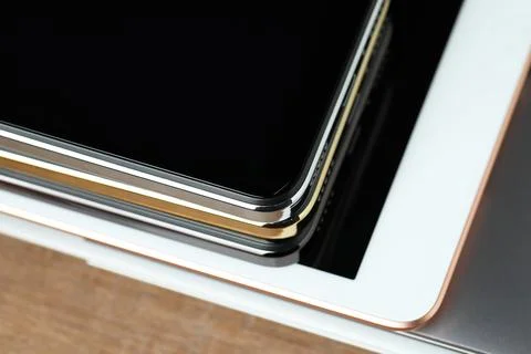 Stack of electronic devices on wooden table, closeup 写真素材