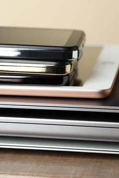 Stack of electronic devices on wooden table, closeup 스톡 사진