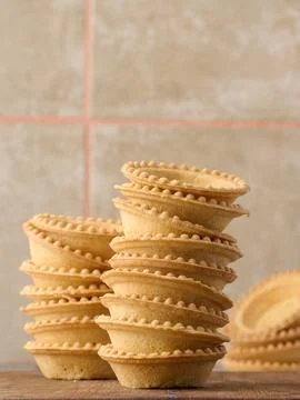Stack of empty baked round canape baskets on a wooden board, round empty ta.. Fotos Stock