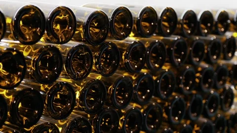 Stack of empty brown glass wine bottles in storage facility of modern indus.. Stock Footage 339411598