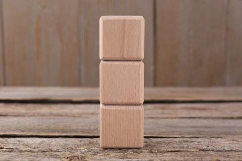 Stack of empty cubes on wooden table, space for text Stockfoto's