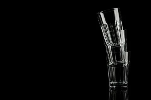 Stack of empty glasses on black background. Space for text 스톡 사진