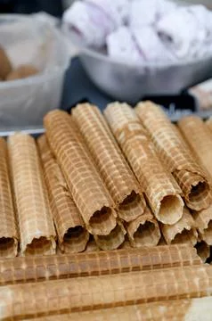 Stack of empty ice cream cones displayed on a counter in a shop Stock Photos