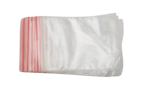 Stack of empty plastic bags with red zipper seals isolated on white backgro.. Stock Photos