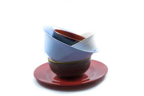 Stack of empty plates and bowls isolated on a white Stock Photos