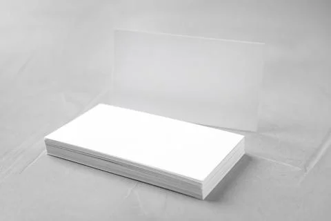 Stack of empty sheets on grey stone table. Mock up for design Stock Photos