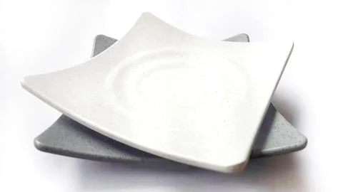 Stack of empty square white and grey plates with ceramic melamin material Stock Photos