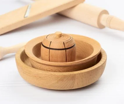 Stack of empty wooden round plates on a white table background Stock Photos