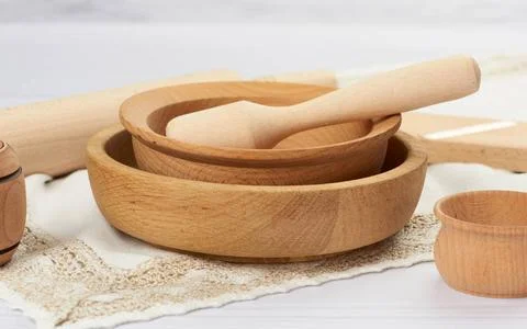 Stack of empty wooden round plates on a white table background stack of em... Stock-Fotos