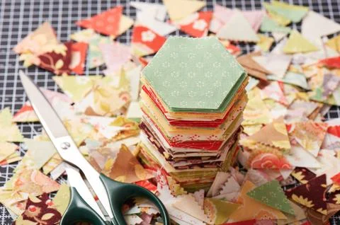 Stack english paper pieced hexagons surrounded by scraps Stock Photos