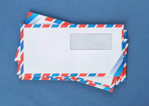 A stack of envelopes on a blue Foto stock