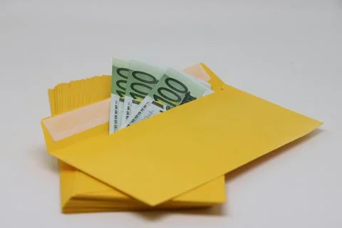 A stack of envelopes. Close-up with an envelope full of euro banknotes on a l 스톡 사진
