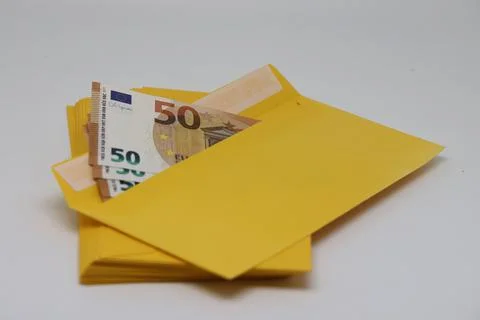 A stack of envelopes. Close-up with an envelope full of euro banknotes on a l Stockfoto's