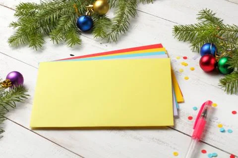 A stack of envelopes of different colors on a white background surrounded by  Foto stock