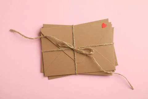 Stack of envelopes on pink background, top view. Love letters Foto stock