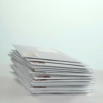 Stack of envelopes with stamps on the table Foto stock