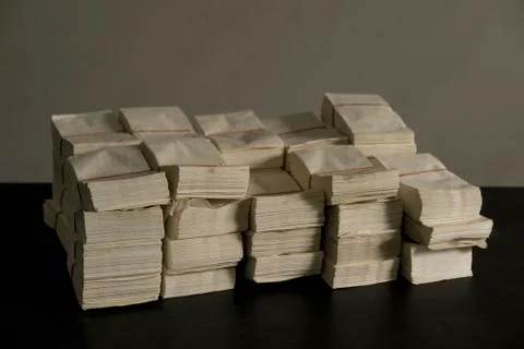 Stack of envelopes on table against wall Foto stock