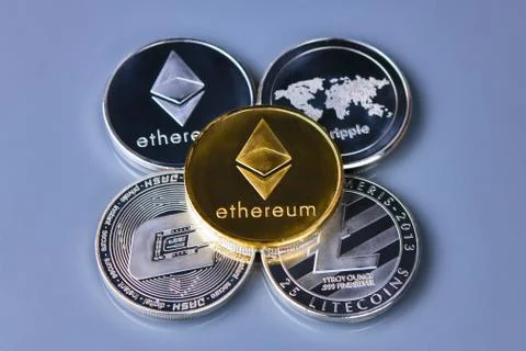 Stack of ether coins or ethereum on gold background Stock Photos