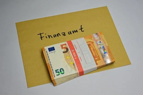 Stack of euro banknotes on envelope labeled Finanzamt symbolizing tax payme.. Stock Photos