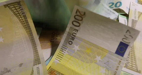 Stack of euro banknotes isolated on a black table.. Financial crisis. Stock Footage 141432002