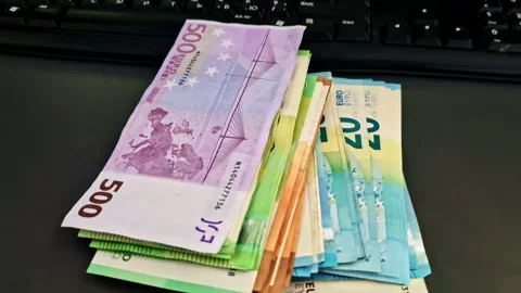 Stack of Euro Banknotes On The Table With Computer Keyboard. - closeup shot Stock Footage 310340532