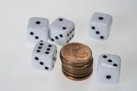 Stack of Euro Cent Coins and five white Dice Stock Photos