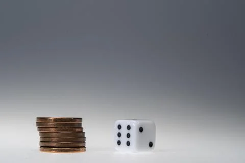 Stack of Euro Cent Coins and white Dice Stock Photos