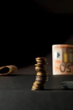 Stack of euro coins and banknotes in a black background Stock Photos