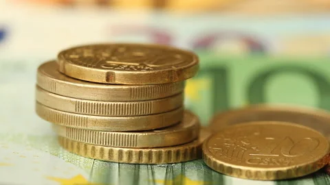 Stack of Euro coins on banknotes with a slider Stock Footage 128343115