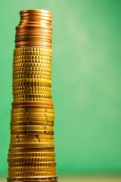 Stack of euro coins in a green background Stock Photos