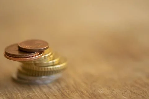 Stack of euro coins on wooden table with copy space Stock Photos