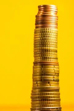 Stack of euro coins in a yellow background Stock Photos
