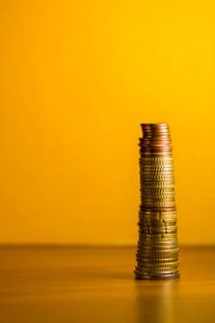 Stack of euro coins in a yellow background Stock Photos