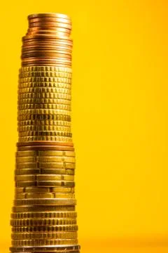 Stack of euro coins in a yellow background Stock Photos