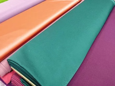 Stack of Fabric Rolls in market Stock-Fotos